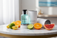 Louis Vuitton Imagination lifestyle shot with citrus and ocean